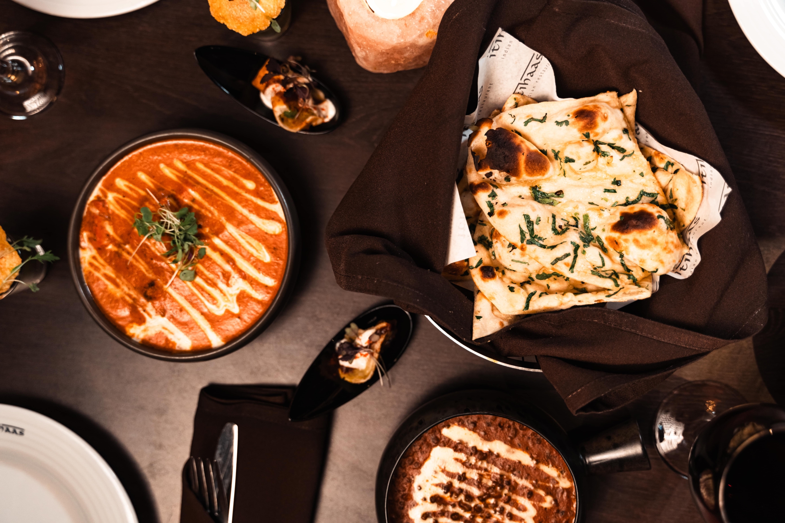 A table laid with curries and rotis